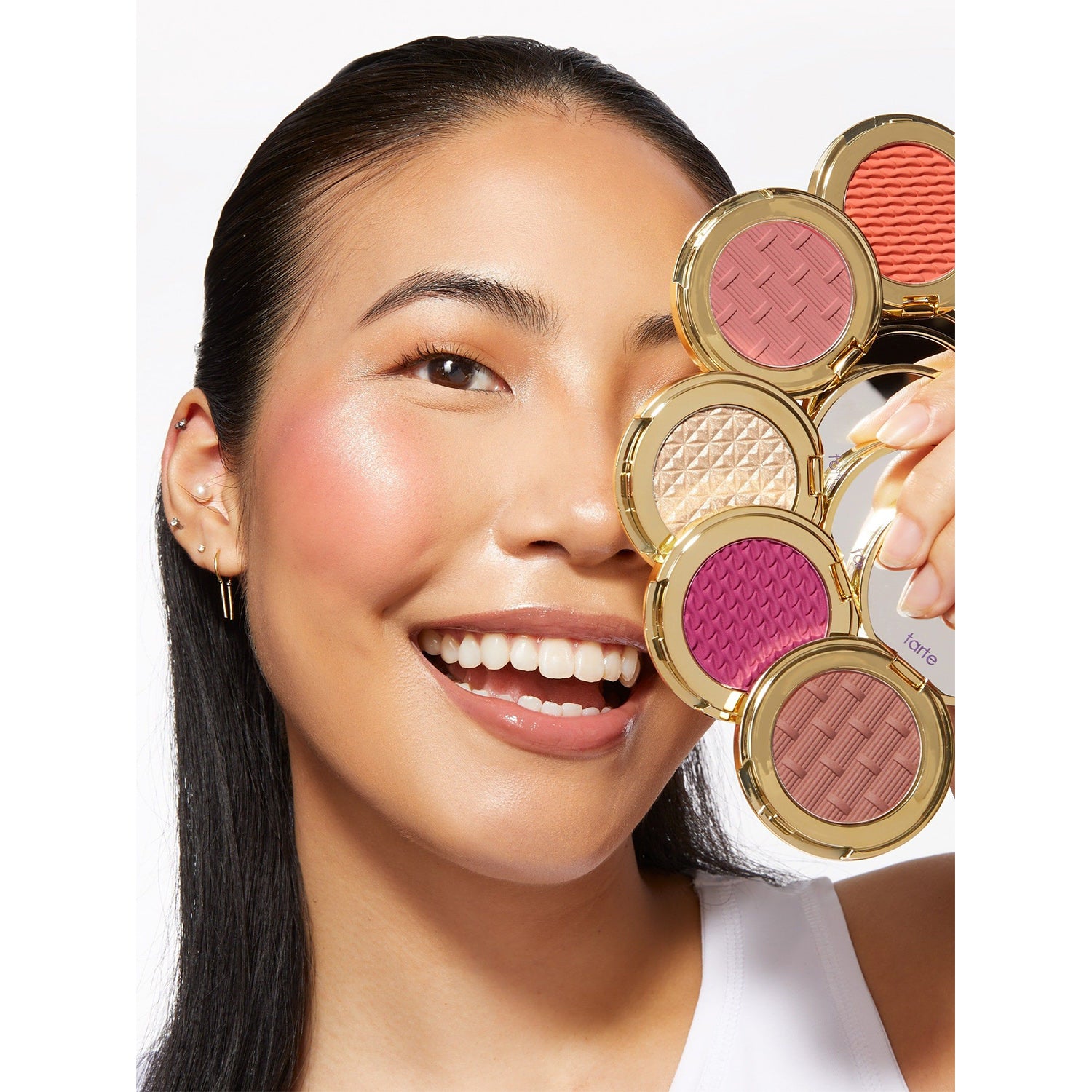 image showing a happy girl showing Tarte Stay Golden Amazonian Clay Blush and Cheek Gift Set for her available at Heygirl.pk for delivery in Pakistan.